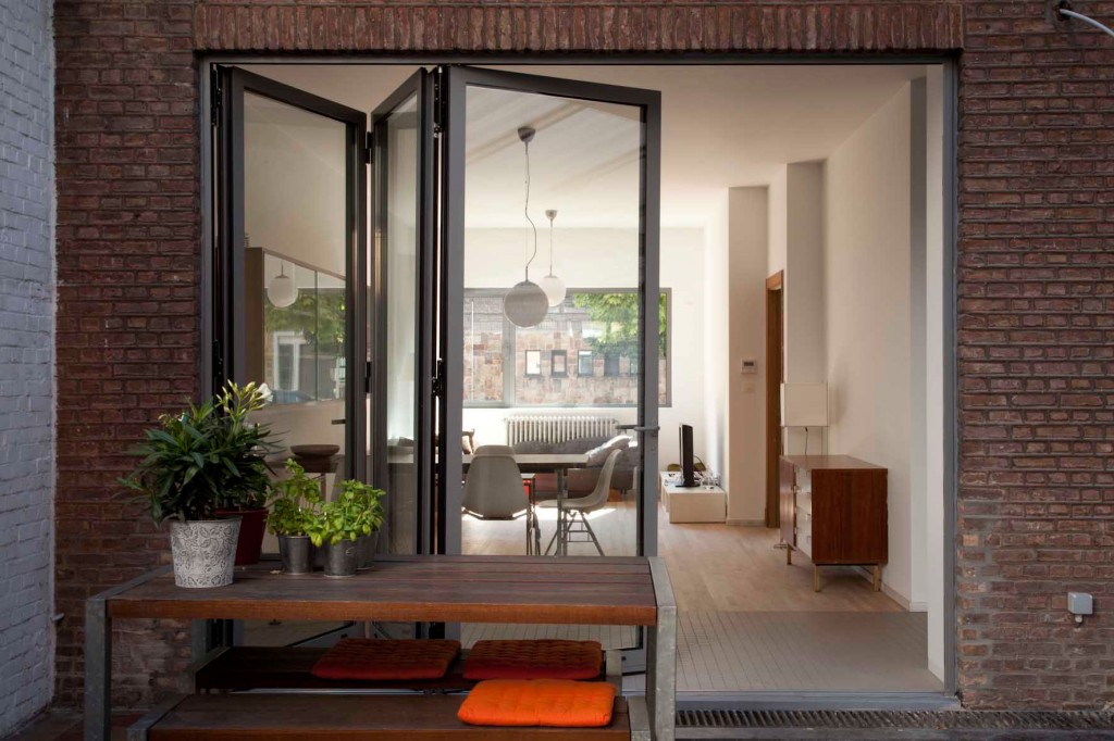 Bi-fold doors fully opened connecting living space to garden