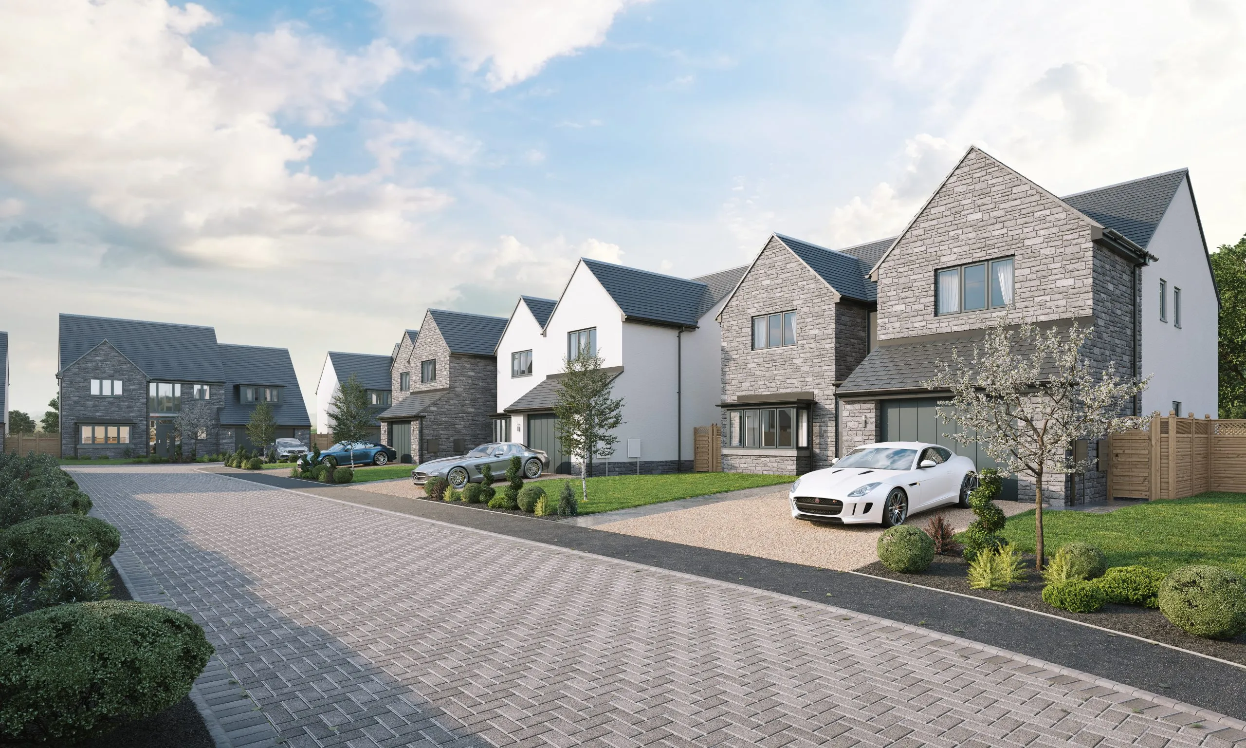 New build housing development with modern grey stone facades and landscaped driveways