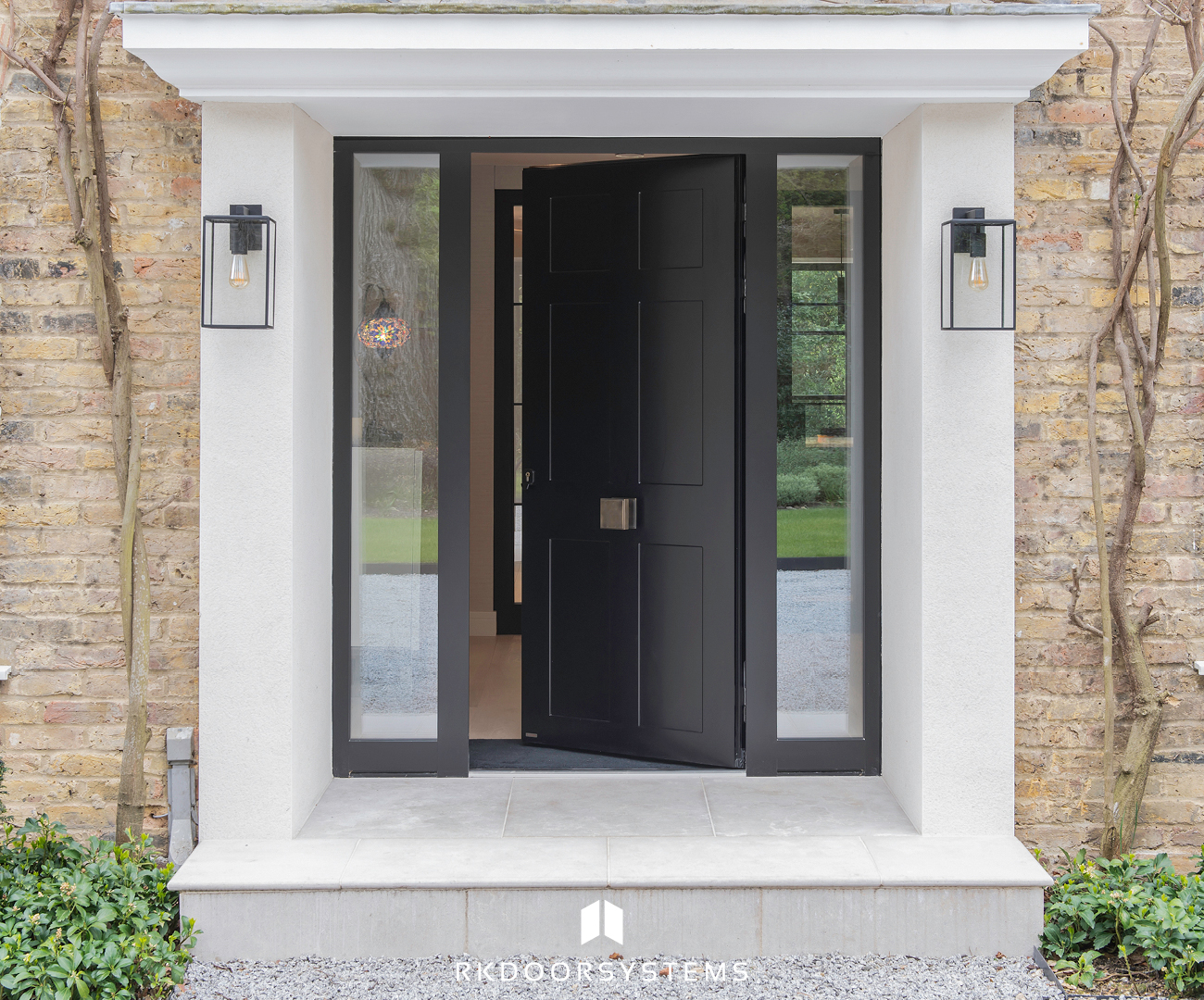 Classic black pivot entrance door on a Georgian property