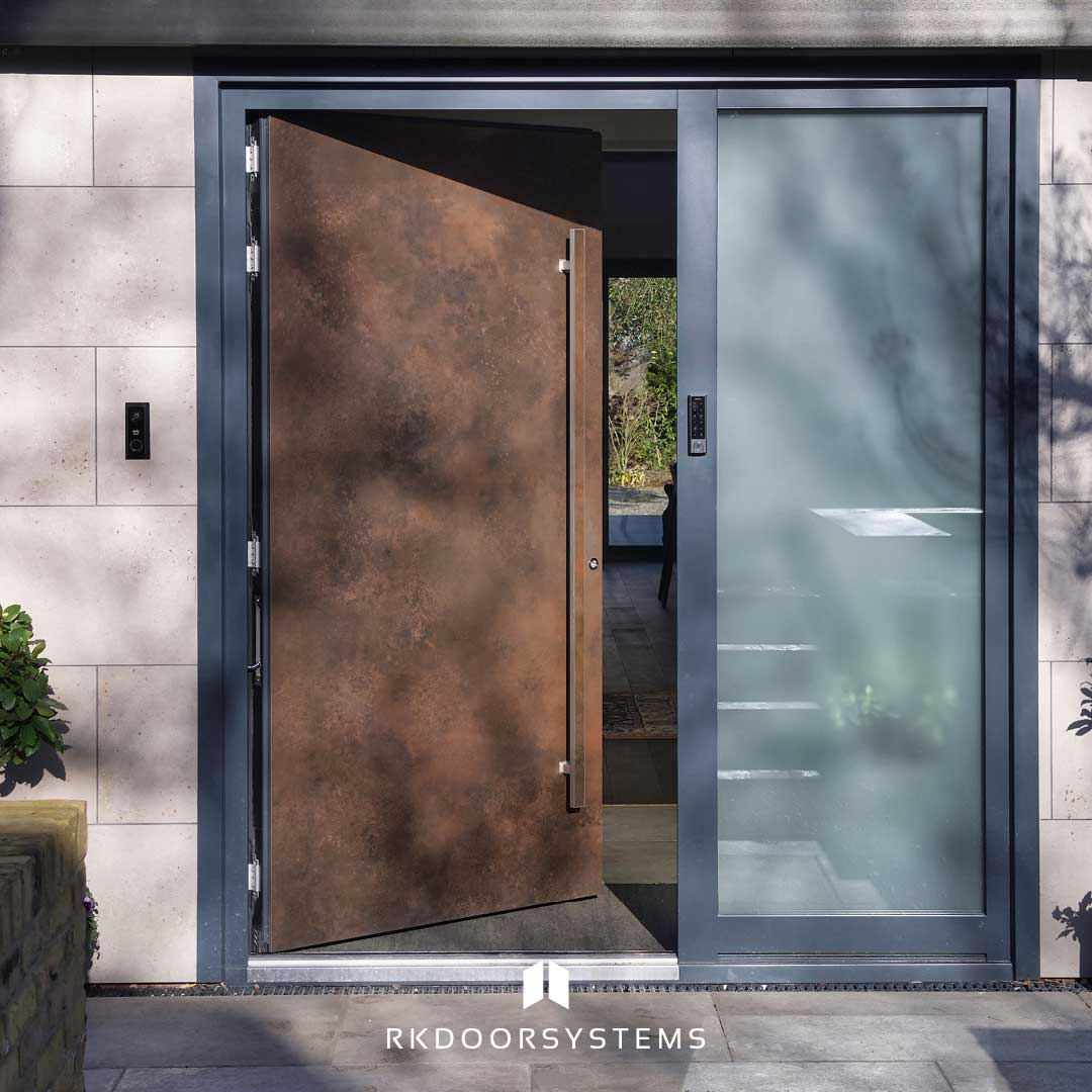 RK Door Systems corten pivot door with architectural detailing