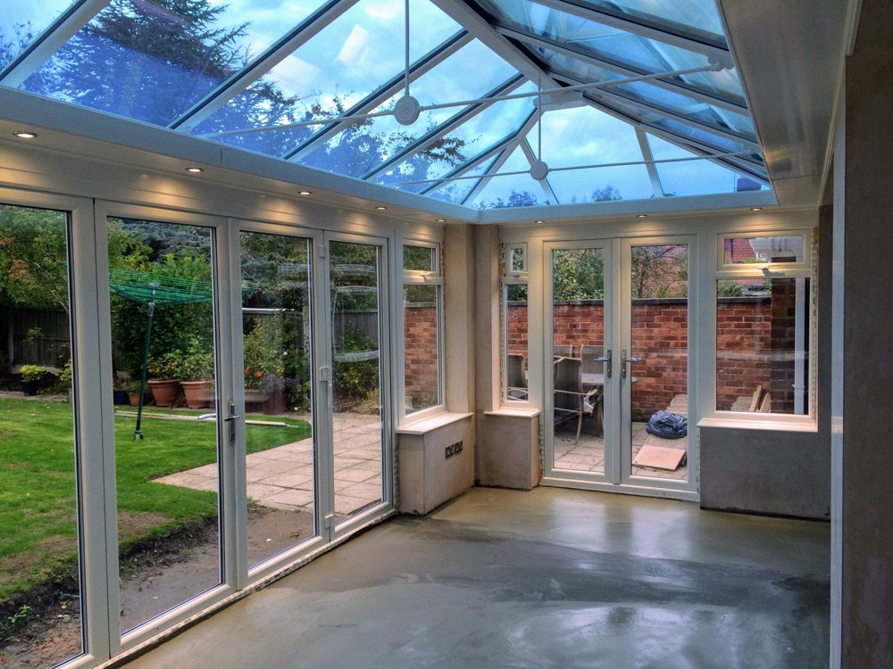 Interior of glazed extension with full-height glass walls