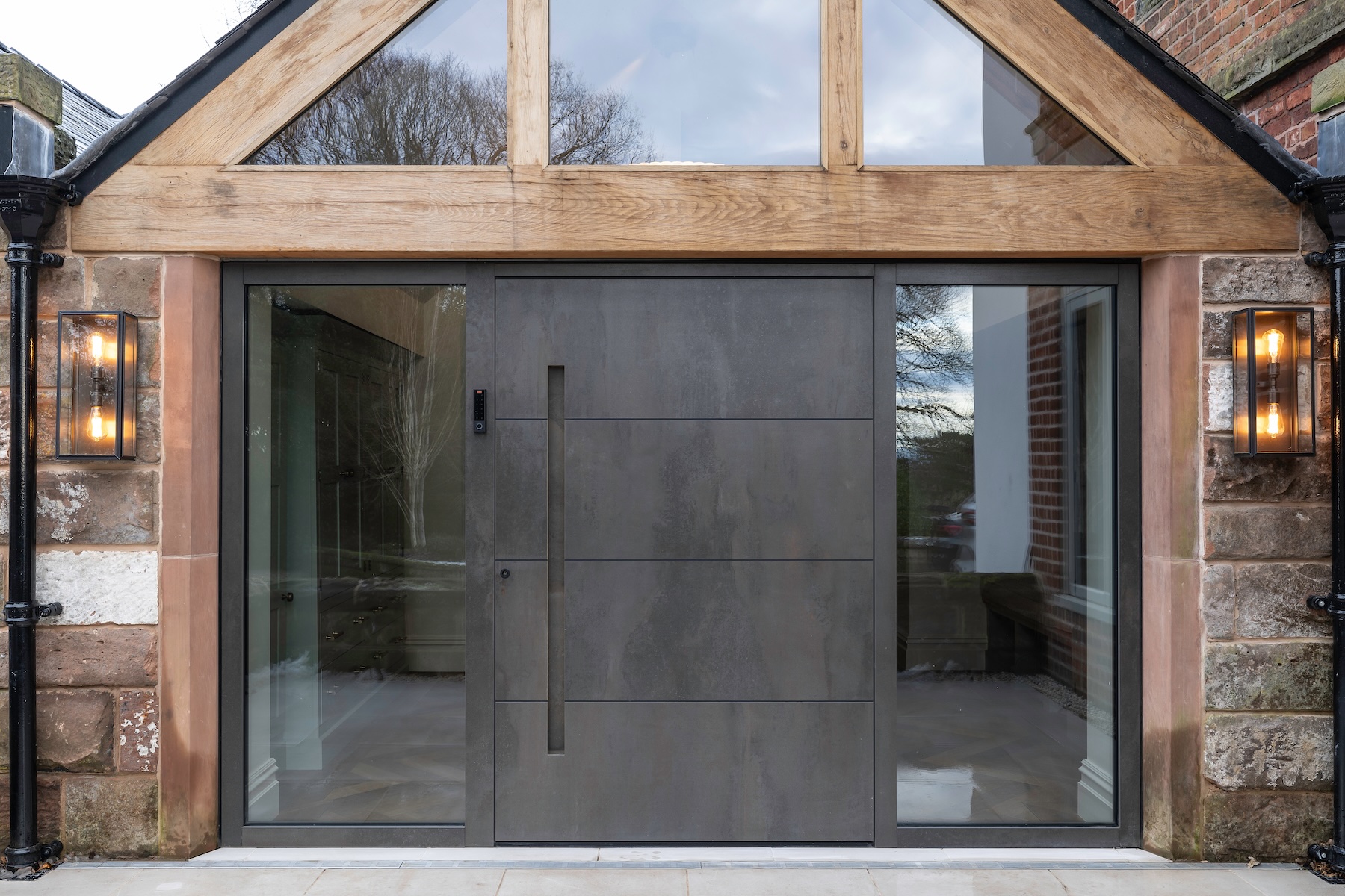 Corten steel pivot door with modern architectural facade