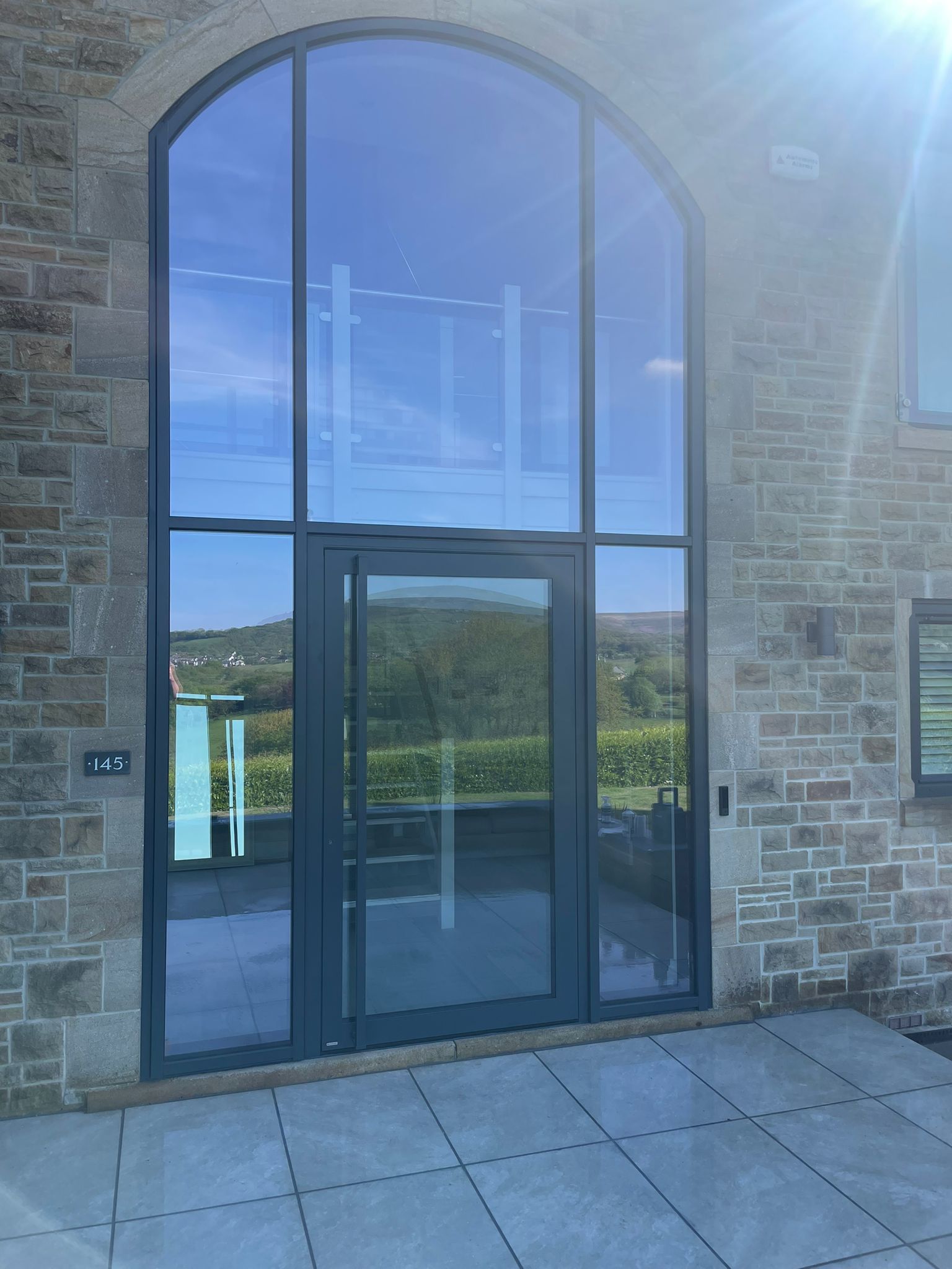 Bespoke aluminium-framed glazing with arched fanlight